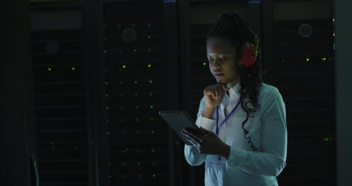 Woman Using Tablet in a Dark Server Room