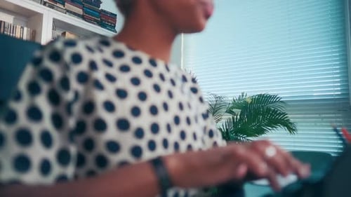 Young Ethnic African American Woman Secretary Typing on Vintage Typewriter