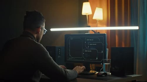 Young Man Mobile Developer Writes Program Code on a Computer Programmer Work in Home Office