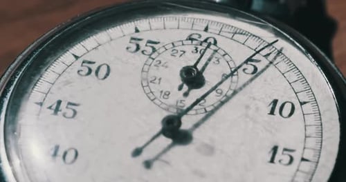 Old Vintage Stopwatch Lies on Wooden Table and Counts the Seconds