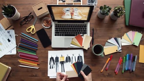 Fashion Designer Sketching Clothing Designs