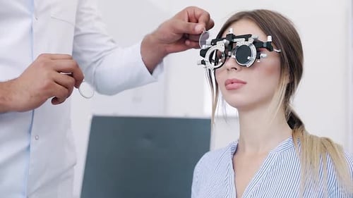 Eye Exam. Woman In Glasses Checking Eyesight At Clinic