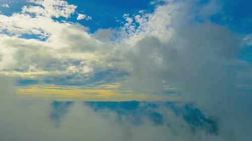White Clouds Rolling Through Mountainous Landscape
