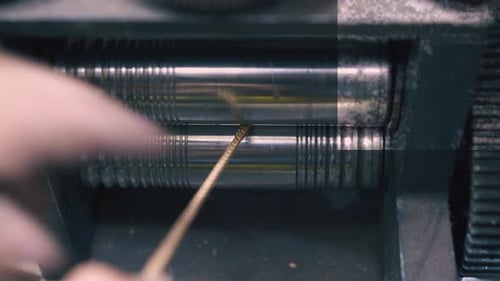 Goldsmith Forgerolls Shiny Chain with Tool in Shop Closeup