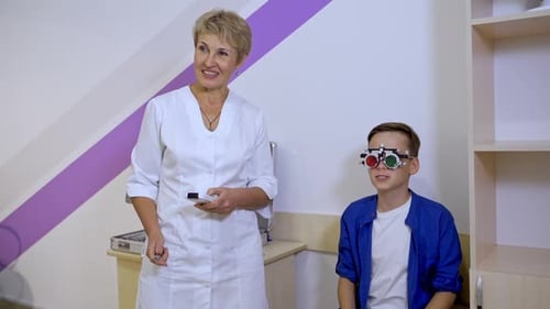 Portrait of a kid boy wearing corrective glasses with replaceable lenses.