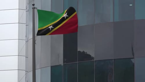 St. Kitts and Nevis National Flag Waving in Wind Against Building
