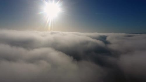 Aerial View, Flying Through Clouds at Sunset