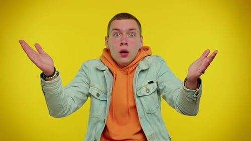 Man Expresses Shock in Front of Yellow Background