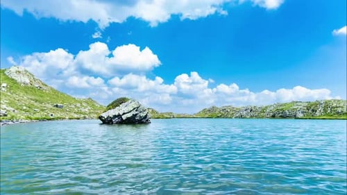 Small Mountain Pond With Moving Clouds