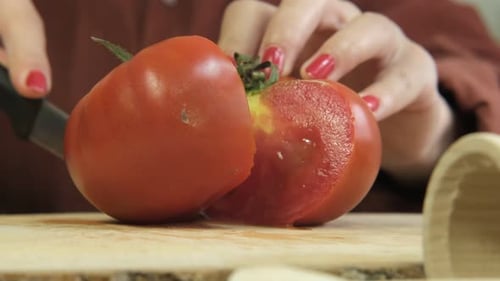 Tomato Slicing on Cutting Board at Home