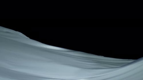 Waving Fabric in Abstract Motion Over Black Background