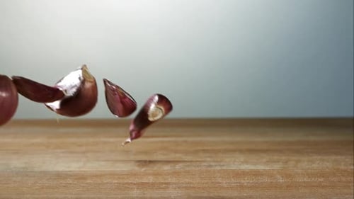 Garlic clove pieces bouncing in ultra slow motion 1500fps on a wooden surface - BBQ PHANTOM