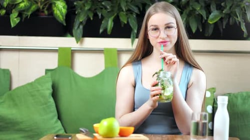 Woman Enjoying Healthy Drink in Urban Cafe