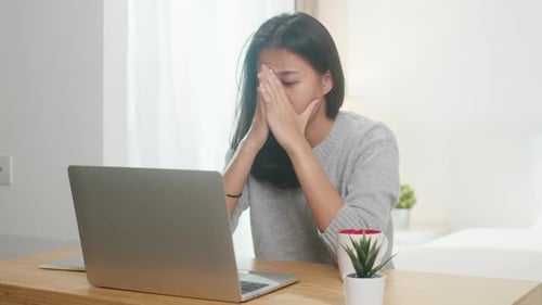 Stressed Woman Working on Laptop at Home