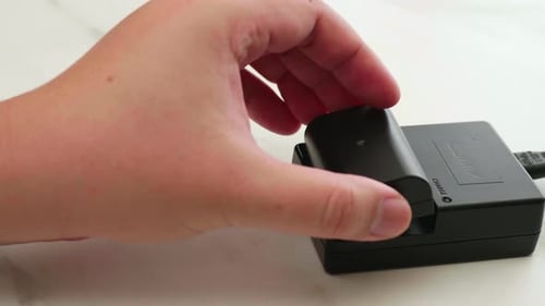 Placing Battery into Black Camera Battery Charger