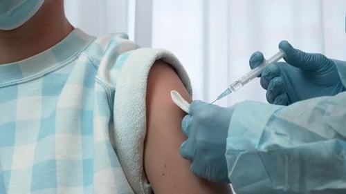 Vaccine Injection in the Arm by Medical Professional