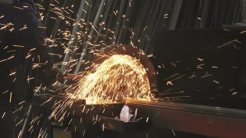 Worker Cuts Metal with Chop Saw Sparks Fly