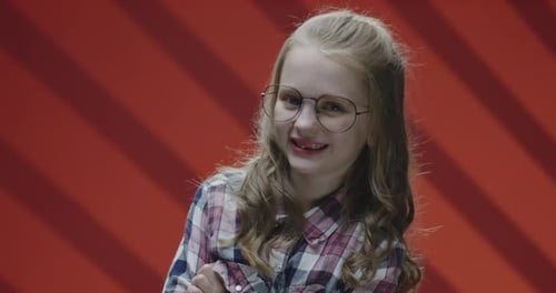 Expressive Girl Laughing in Front of Red Background