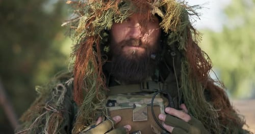 Serious Brave Soldier Dressed in Military Uniform Guards Borders of the Country Hides in Forest