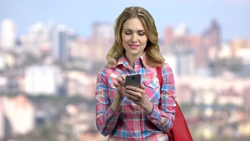 Woman Using Smartphone in Urban Environment