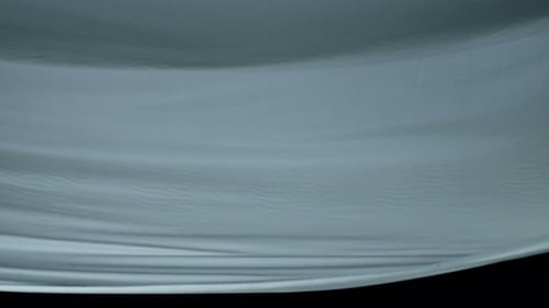 Blue Fabric Waving in Front of Black Background