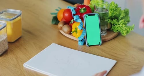 Nutritionist Talking on Video Chat Using Smartphone with Green Screen at Work Online Consultation