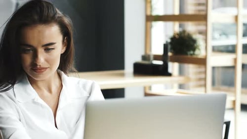 Freelance Woman Working Remotely in Cafe and Talking on Cellphone