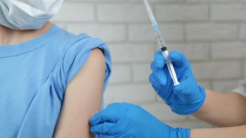 Medical Professional Giving Injection to Patient