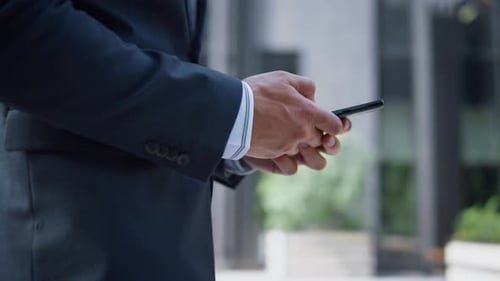Man in Suit Uses Phone Outdoors in City