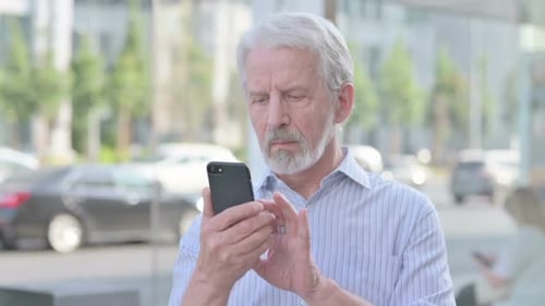 Adult Using Phone in City