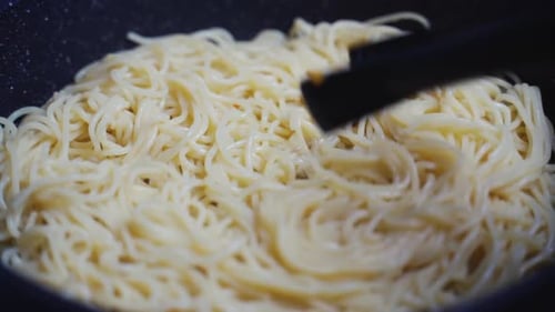 Close Up of Cooking Spaghetti with Tongs