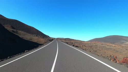Long way asphalt straight road from ground pov. Vehicle driving and traveling outdoors concept.