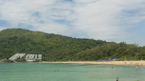People Relaxing and Sunbathing at Beach