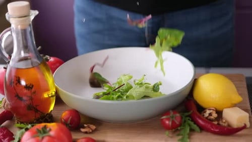 Lettuce Being Dropped Into a Salad Bowl