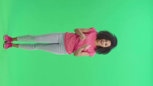 Smiling Woman Gesturing Positively on Green Screen