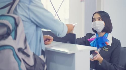 Smiling Employee Assists Traveler at Airport Reception