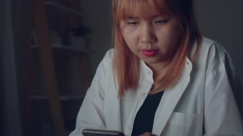 Woman using mobile phone at home. female insomnia bored and tired while checking social media