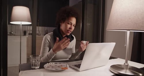 Woman Using Laptop for Virtual Doctor Appointment