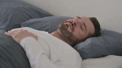 Man Sleeping in Bed Peacefully