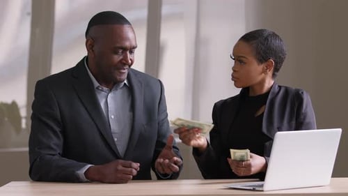 Business Agreement: Money and Handshake in Office