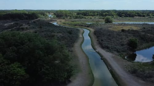 Drone footage of the Dutch dune landscape reflection of the clouds in the water.