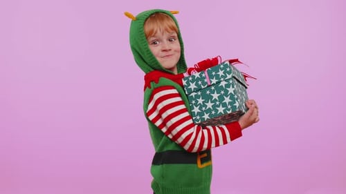 Happy Child Elf Holding Christmas Present