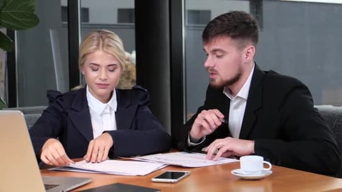 Business Colleagues Reviewing Charts and Graphs Together