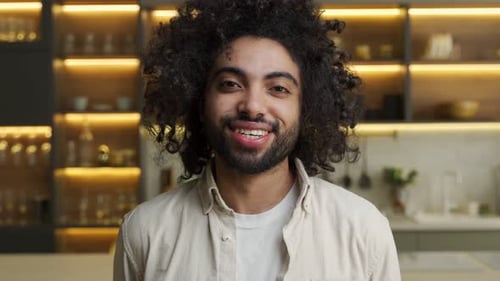 Smiling Man in Kitchen Licks His Lips