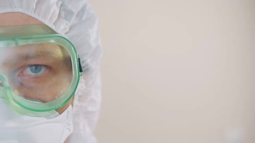 Close Up of Person in Protective Suit and Goggles