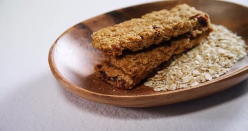 Granola bar and oatmeal in bowl