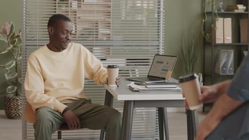 Office Colleagues Conversing with Coffee at Workplace