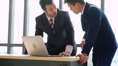 Two Business People Talk Project Strategy at Office