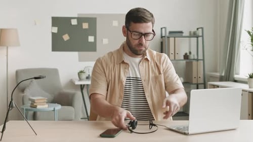 Man Starts Work at Home Office, Puts on Headset