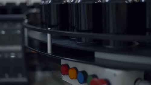 Empty Black Beer Cans On Conveyor System Of Canning Machine In The Brewery Plant